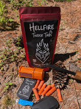 Hellfire Tinder Tabs packaging with matches and fire starter on a forest floor background