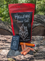Hellfire Tinder Tabs packaging with fire starter on a wooden surface